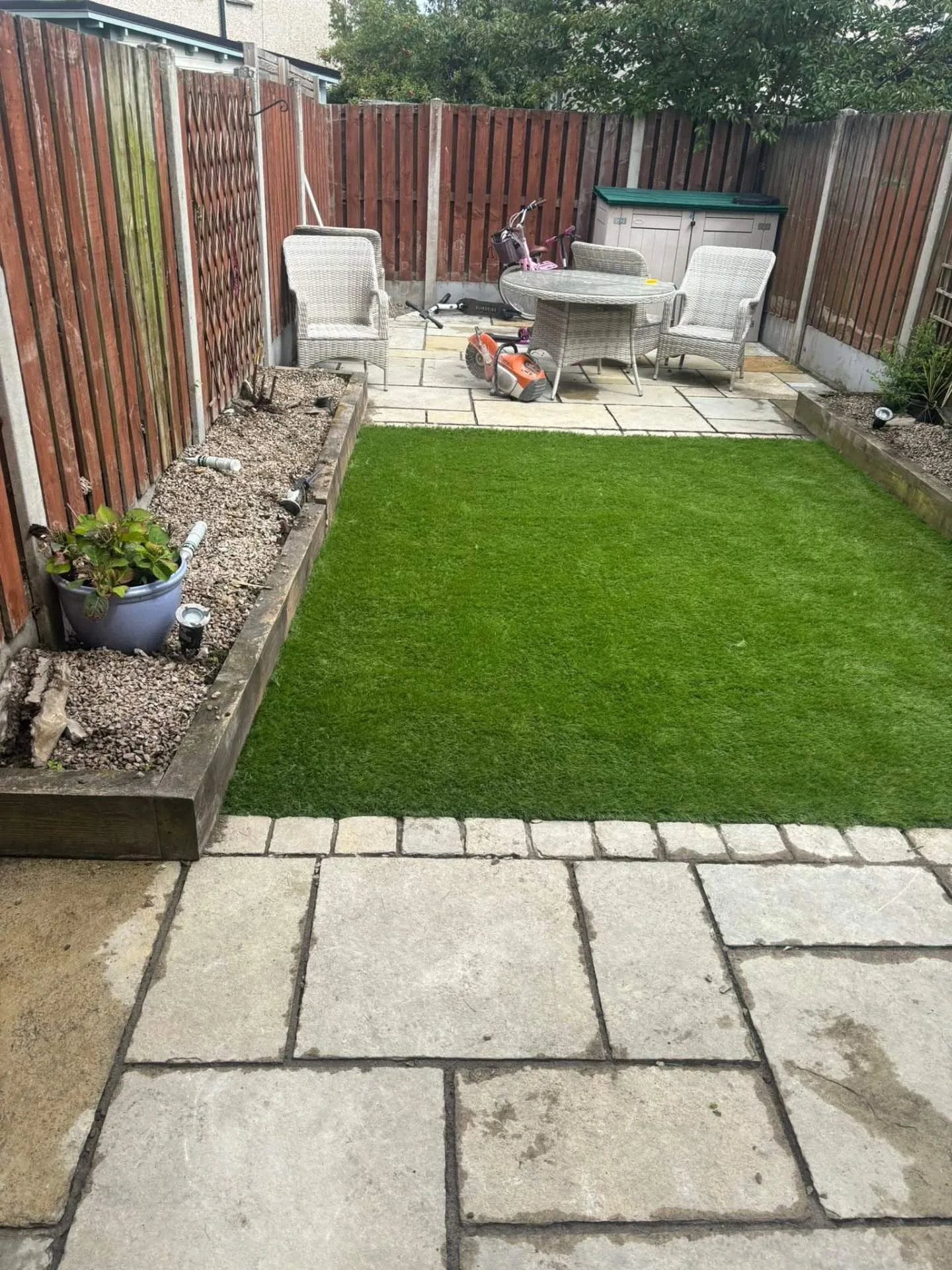Finished rear garden by SPG Garden — sandstone patio and artificial lawn